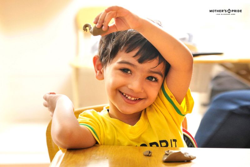 Smiling child enjoying a joyful moment in the nurturing environment of a playgroup school in Pataudi.