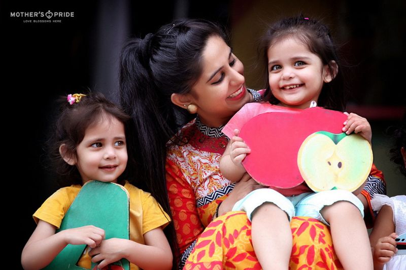 Teacher engaging children with interactive educational games in a playgroup in Pataudi